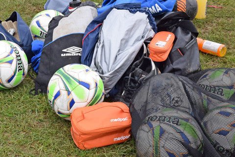 bright orange medpac bag in a file of football kits to show it is bright and stands out